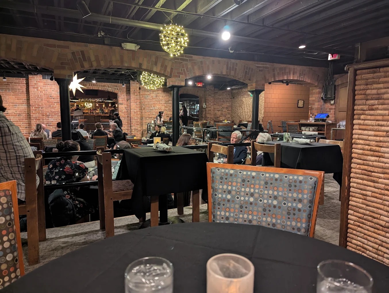 Candlelit dining room with exposed brick